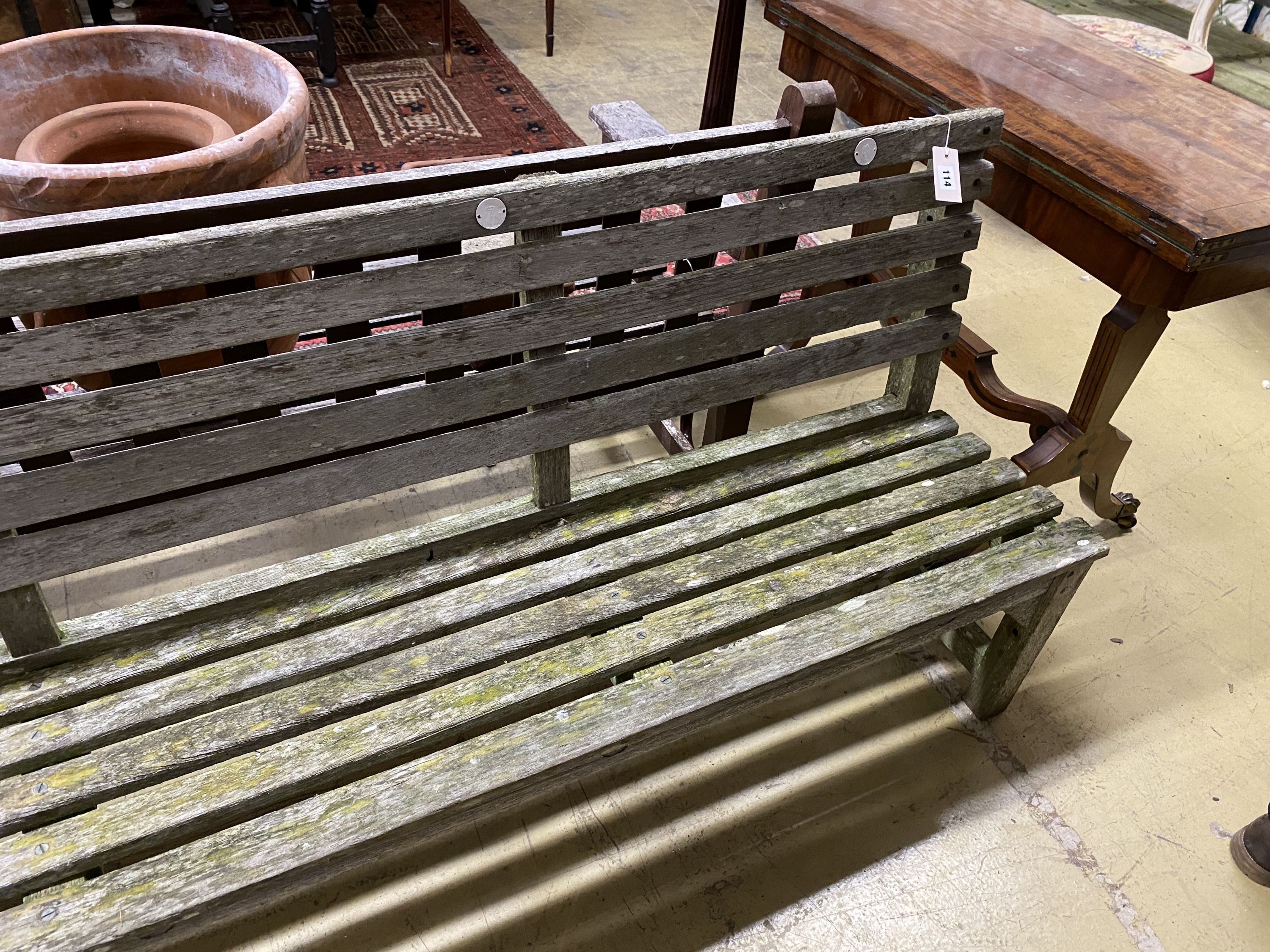 A weathered teak garden bench, length 183cm, depth 39cm, height 80cm
